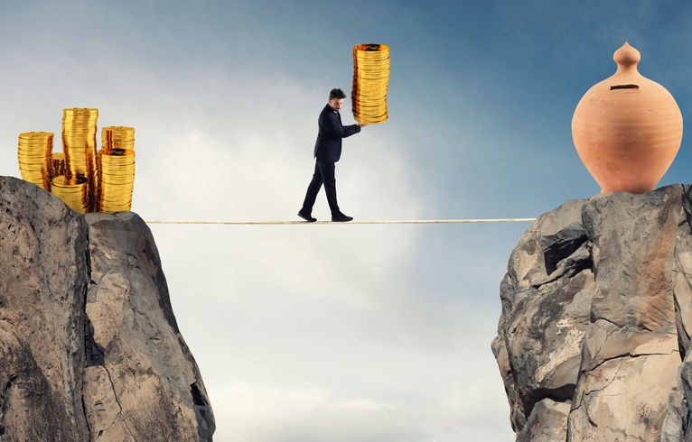 man on a tight rope holding coins