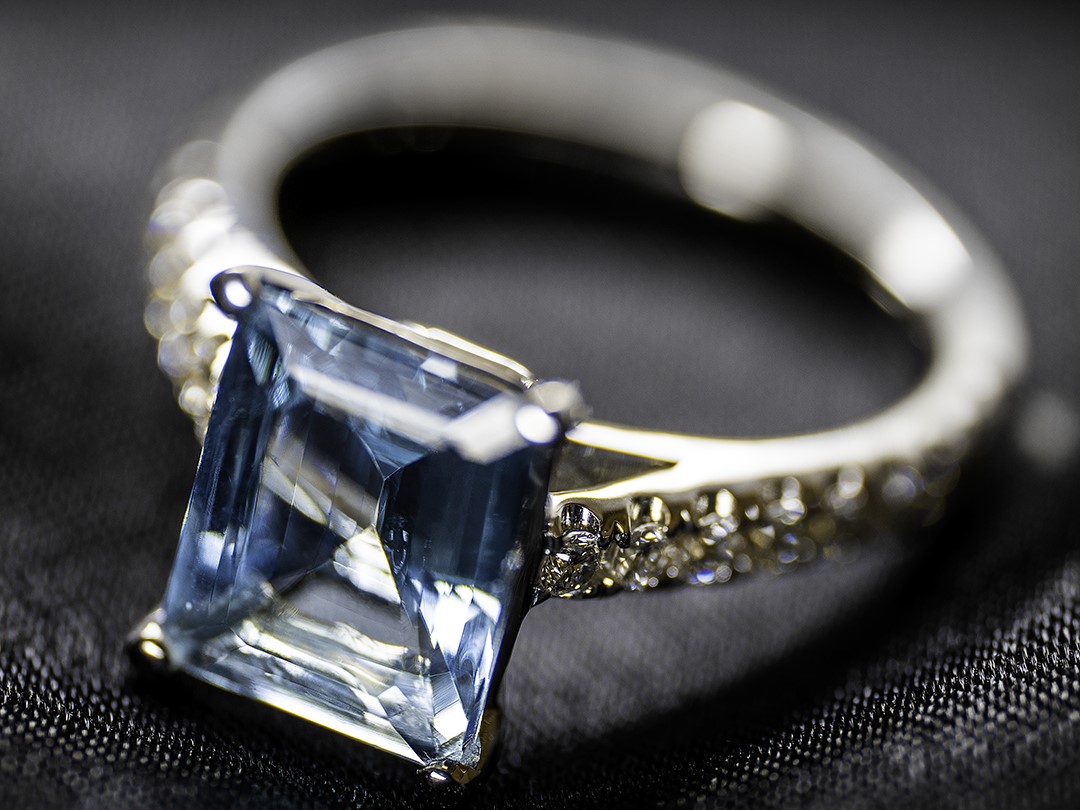 Aquamarine ring laying on a black cloth